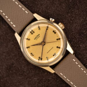 Vintage Vulcain Cricket 307004 alarm wristwatch, champagne dial with warm patina, on taupe leather strap