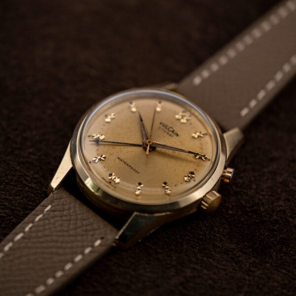 Vulcain Cricket alarm watch angled view, aged champagne dial, faceted applied markers, tarnished dauphine hands