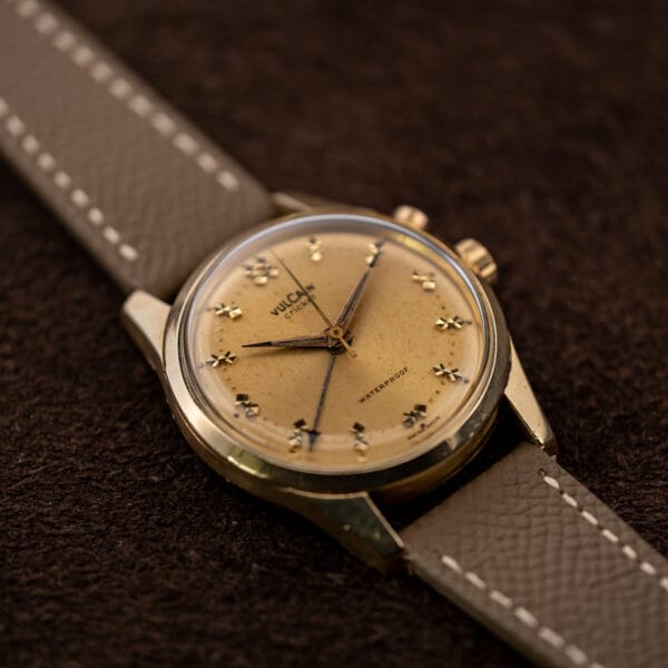 Vulcain Cricket 307004 gold capped case at an angle, wear through to base metal at the lower right