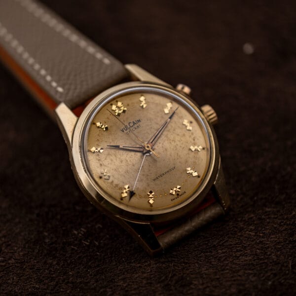 Vintage Vulcain Cricket alarm watch, heavily patinated champagne dial, sharp lug facets, taupe Saffiano leather strap