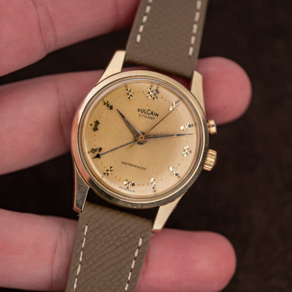 Vintage Vulcain Cricket 307004 front view, champagne dial with fine crazing and tarnished dauphine hands