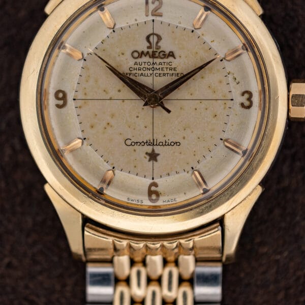Vintage Omega Constellation dial macro showing CHRONOMETRE OFFICIALLY CERTIFIED printing, applied markers and faceted crown