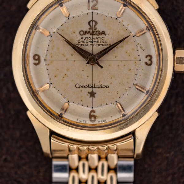 Vintage Omega Constellation dial macro showing CHRONOMETRE OFFICIALLY CERTIFIED printing, applied markers and faceted crown