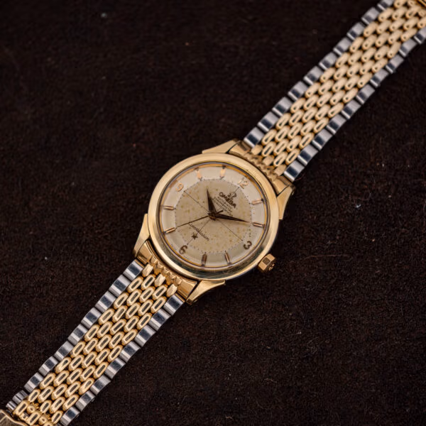 Omega Constellation 2852 pie-pan dial watch photographed diagonally on dark fabric, dauphine hands darkened with age