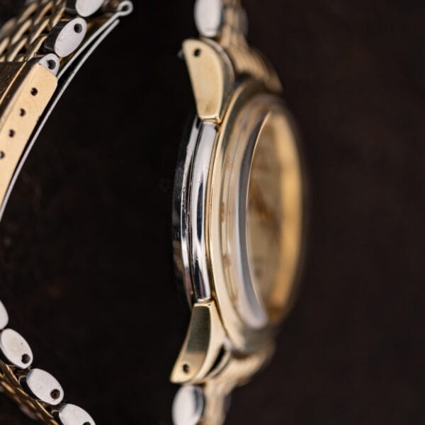 Omega Constellation case profile with domed acrylic crystal and two-tone gold filled expansion bracelet