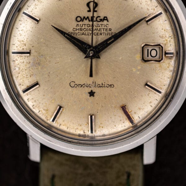 Omega Constellation 168.004 lower dial detail with script signature, applied star and central seconds hand