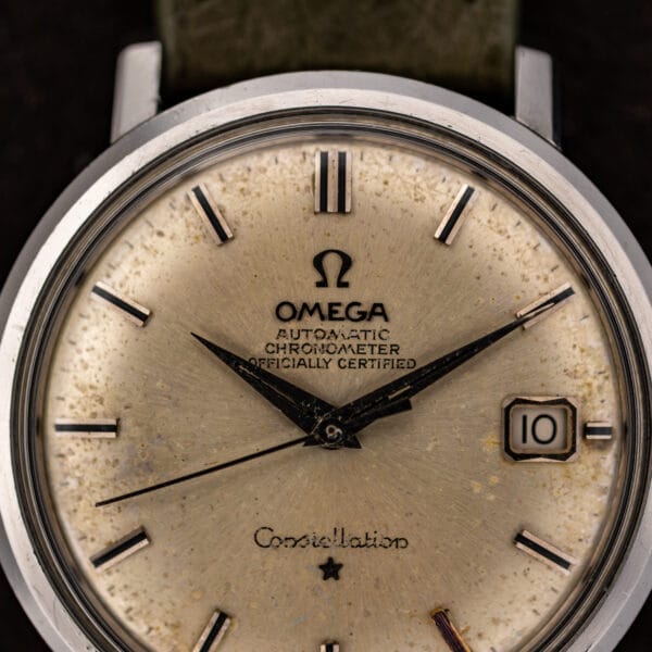 Close view of Omega Constellation 168.004 dial showing chronometer lettering, baton markers and framed date window