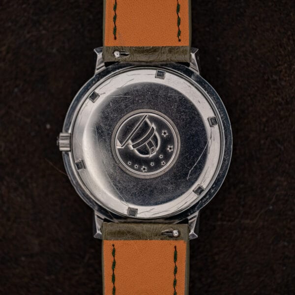 Omega Constellation 168.004 caseback with observatory medallion, surrounding stars and the undersides of the strap