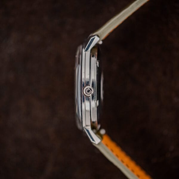 Crown-side profile of Omega Constellation 168.004 showing the Omega-signed crown, raised crystal and angled lugs