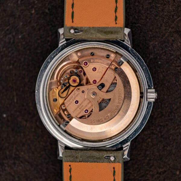 Open Omega Constellation 168.004 showing its copper-toned automatic movement and rotor signed OMEGA WATCH Co SWISS