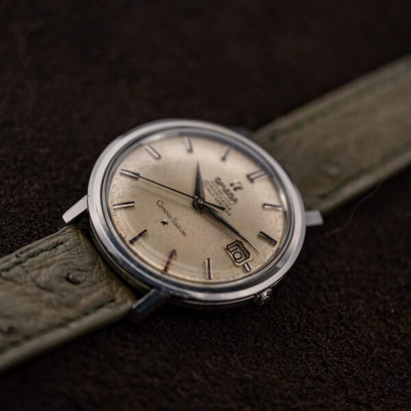 Omega Constellation 168.004 resting at a shallow angle, with winding crown and lower strap visible