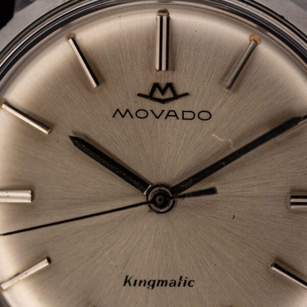 Movado Kingmatic 15161 dial macro showing the Movado emblem, central hands and fine radial brushing