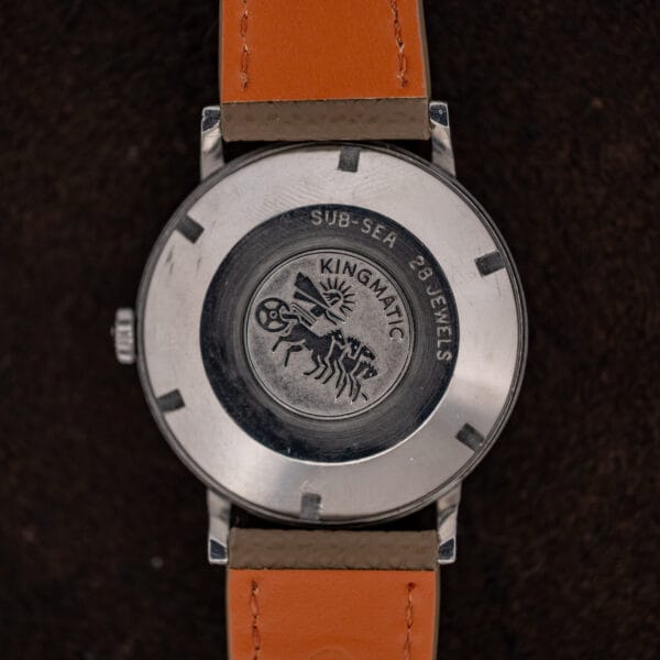Movado Kingmatic 15161 caseback with horse-drawn chariot medallion, SUB-SEA lettering and orange leather strap lining