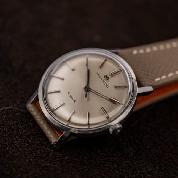 Low oblique view of Movado Kingmatic 15161 with the crown in the foreground and strap extending right