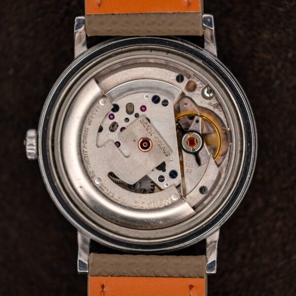 Open Movado Kingmatic 15161 showing the automatic movement, broad signed rotor and balance beside the regulator