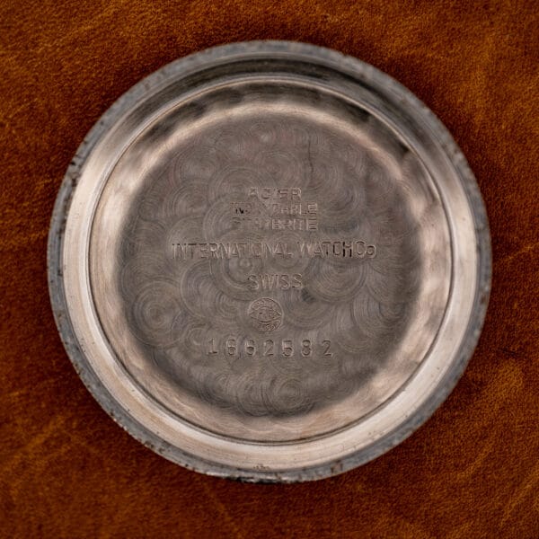 Inside IWC caseback with ACIER INOXYDABLE STAYBRITE stamps, maker's signature and number 1662582