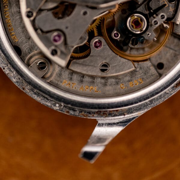 IWC movement detail with C. 853 and PAT. APPL. markings beside the balance assembly