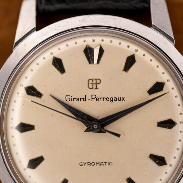 Girard Perregaux Gyromatic dial close-up showing applied GP emblem and dauphine hands