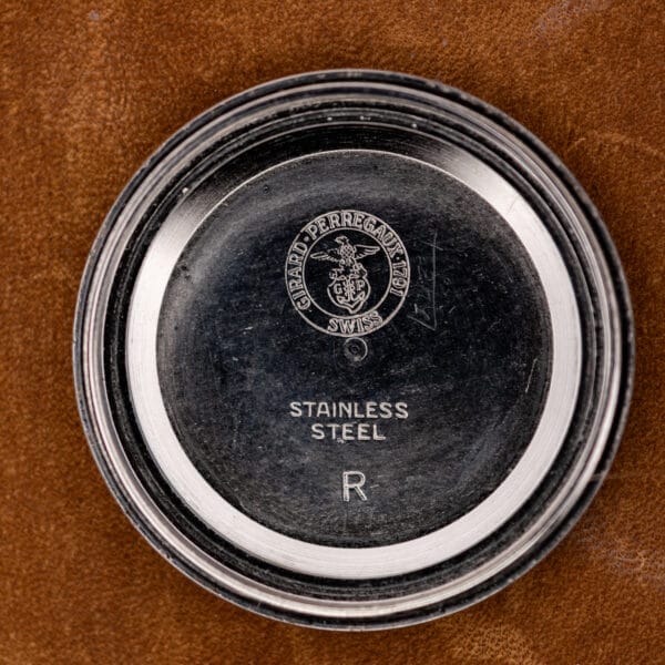 Girard Perregaux inner caseback with signed circular emblem and stainless steel stamps