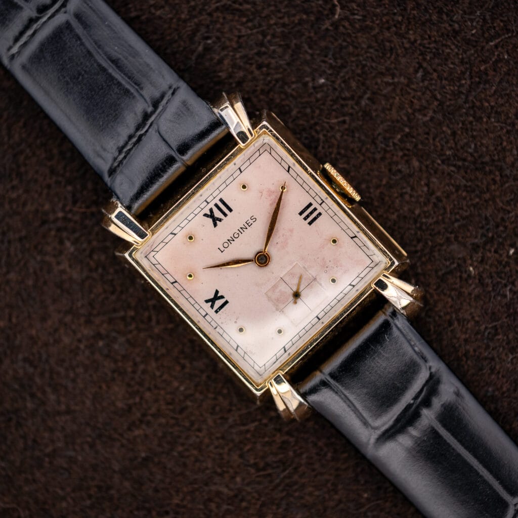 Longines square dress watch with rose dial, Roman numerals, sculpted lugs and black leather strap