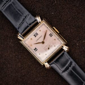 Longines square dress watch with rose dial, Roman numerals, sculpted lugs and black leather strap