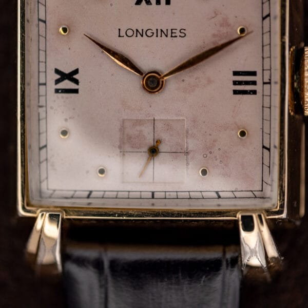 Lower Longines dial detail with crosshair seconds register, railway minute track and flared gold filled lugs