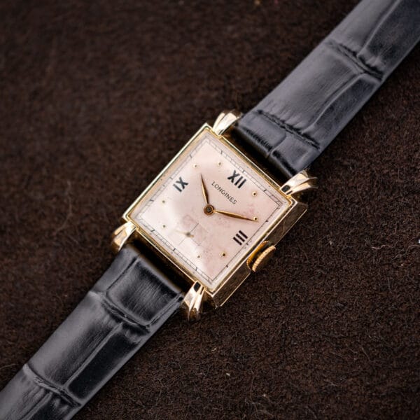 Angled Longines Art Deco square case and rose dial on patterned black leather strap