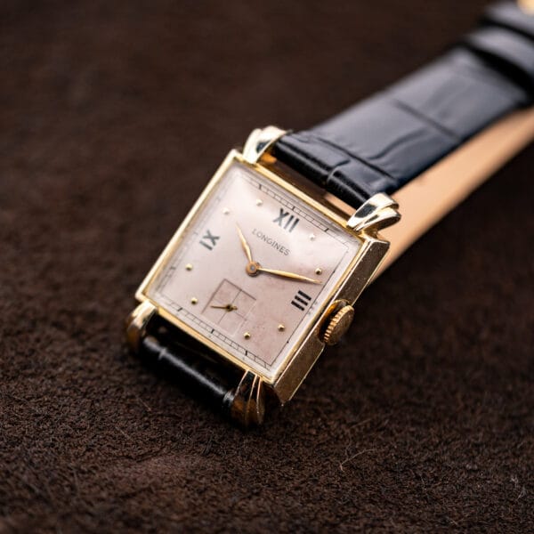 Three-quarter Longines front view with Roman numerals, applied dot markers and knurled winding crown