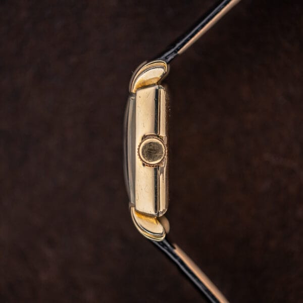 Longines crown-side case profile with plain winding crown, raised crystal and curved lug ends