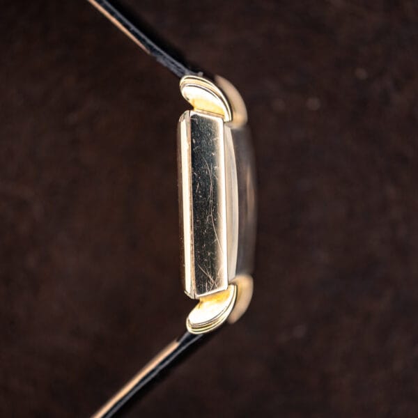 Opposite Longines case profile showing straight flank, raised crystal and arched sculpted lugs