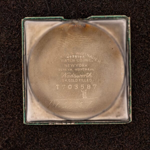 Longines inner caseback signed Longines-Wittnauer and Wadsworth with 10k gold filled stamp and case number