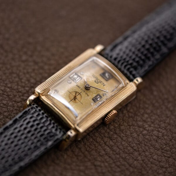 Crown-side view of Gruen Precision 335/756 showing its raised crystal, ridged bezel and black lizard strap