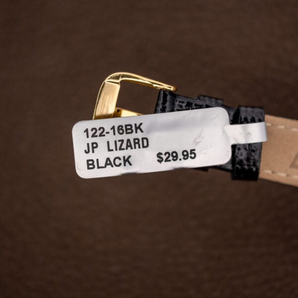 Black lizard strap and gold-tone pin buckle on Gruen Precision 335/756, with the attached strap tag