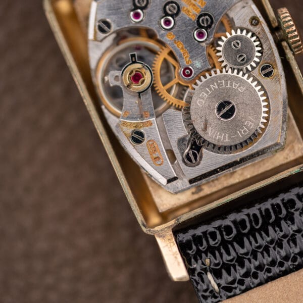 Gruen Precision 335/756 movement detail showing the balance assembly beside the winding wheel marked VERI-THIN PATENTED