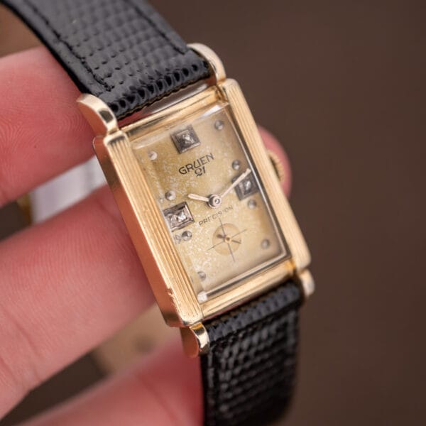 Hand-held Gruen Precision 335/756 showing diamond hour markers, small seconds and pale mottling across the champagne dial