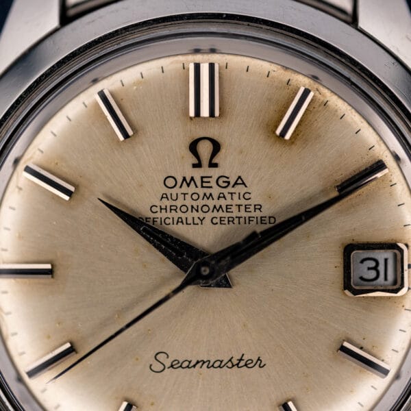 Dial close-up of Omega Seamaster 168.024 showing CHRONOMETER OFFICIALLY CERTIFIED lettering, pointed hands and framed date