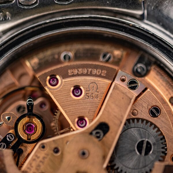 Omega caliber 564 movement close-up showing the numbered bridge, jewel settings and engraved serial number 29397902