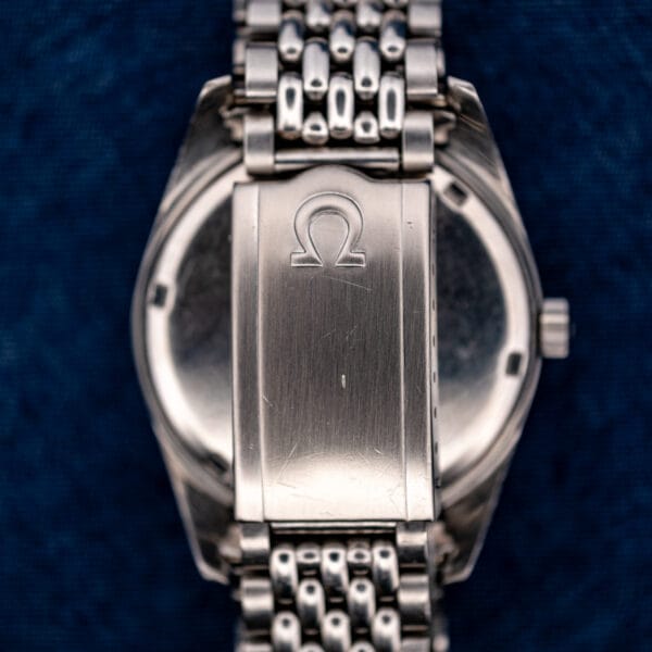 Omega-signed folding clasp on the Seamaster 168.024 steel bracelet, viewed over the back of the watch