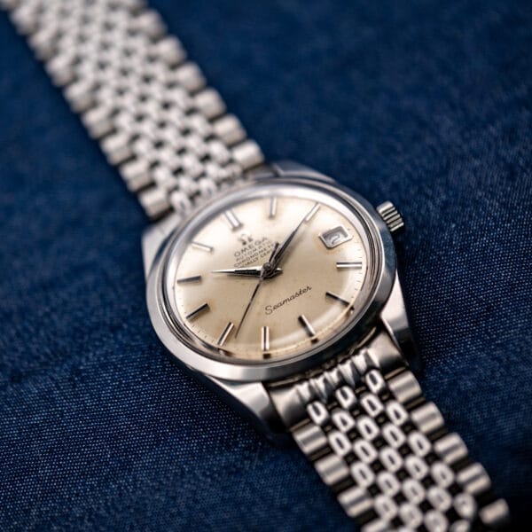Oblique Omega Seamaster 168.024 view with the lower bracelet in the foreground and winding crown beside the dial