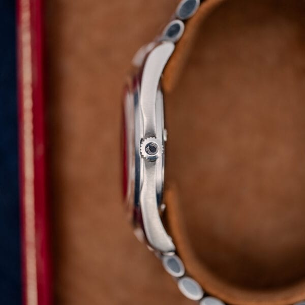Crown-side profile of Omega Seamaster 168.024 showing the Omega-signed crown, crystal edge and curved lugs