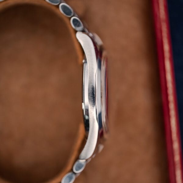 Opposite-side profile of Omega Seamaster 168.024 showing the smooth case flank and bracelet ends on a display cushion