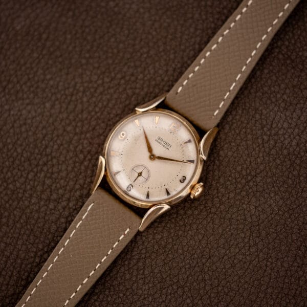 Full Gruen Precision 415/932 laid face-up with its stitched taupe Saffiano leather strap extended