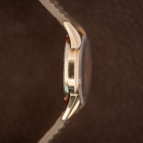Opposite-side profile of Gruen Precision 415/932 showing the case edge, projecting crystal and downward-curving lugs
