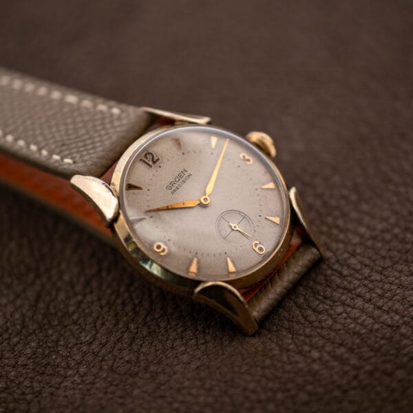 Gruen Precision 415/932 resting at an angle with the lower fancy lug framing its off-white dial