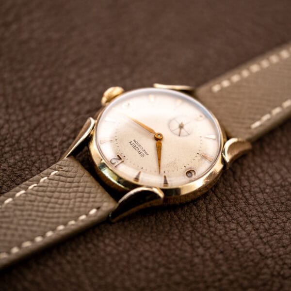 Low view from twelve o’clock of Gruen Precision 415/932, showing the upper lugs and textured leather strap