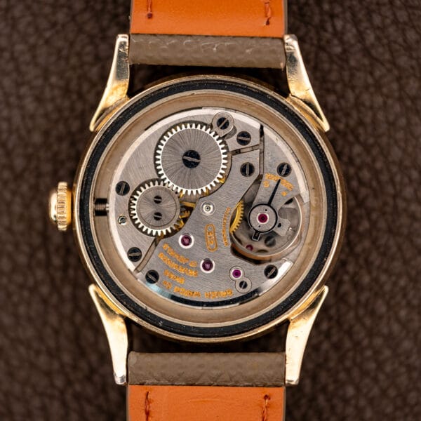 Open Gruen Precision 415/932 case displaying the signed caliber 415 manual-wind movement and winding wheels