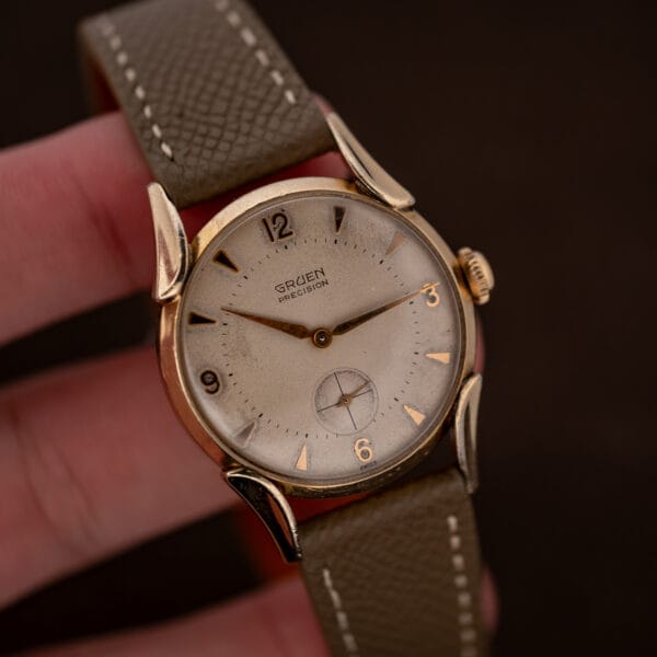 Gruen Precision 415/932 held against fingers, showing the full dial, winding crown and flared lugs