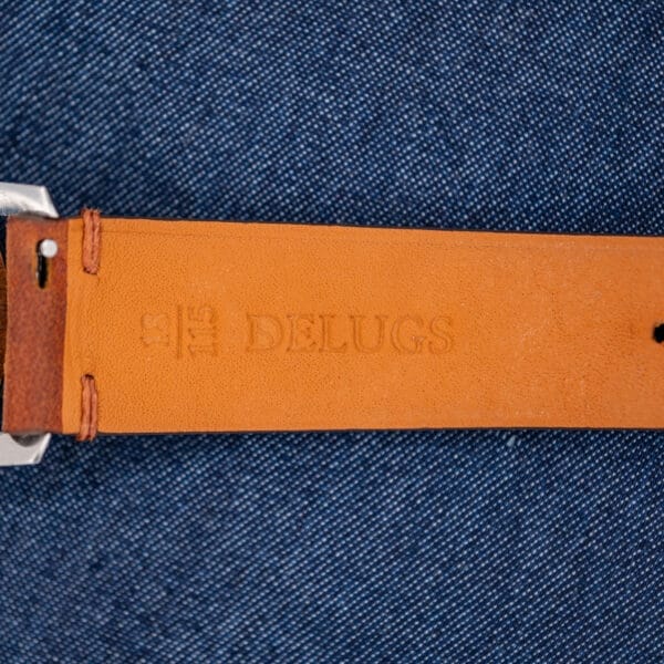 Underside of the Girard Perregaux Sea Hawk leather strap showing the DELUGS stamp and stitched attachment end
