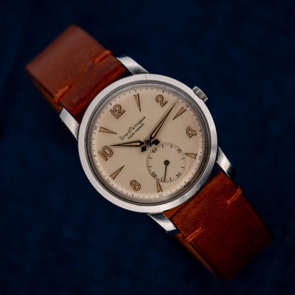 Angled front view of Girard Perregaux Sea Hawk with Arabic numerals, small seconds and curved brown strap