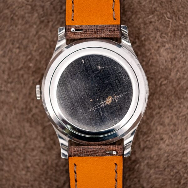 IWC solid caseback viewed between strap undersides with quick-release spring bar tabs